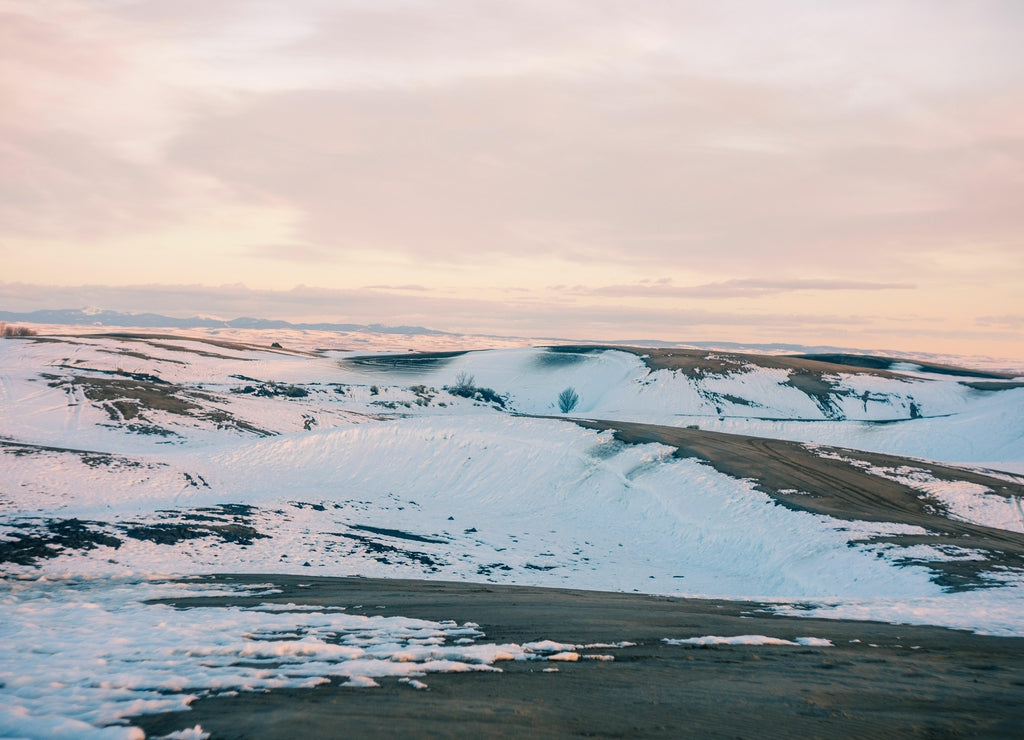 Beautiful bright sunset sky over snowy sand dunes in Saint Anthony, Idaho