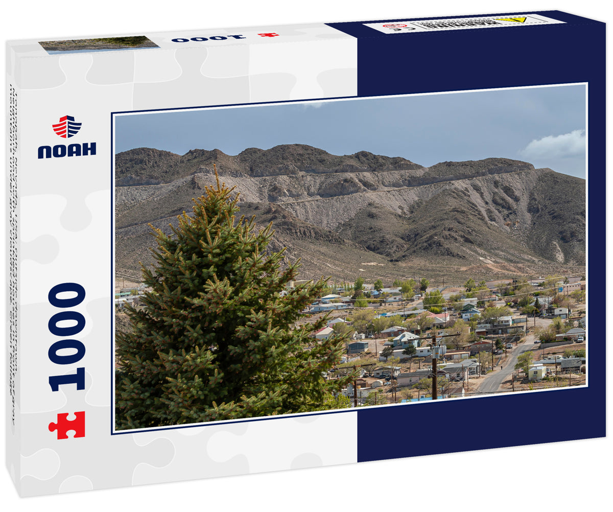 Tonopah, Nevada, USA: Outside downtown. Neighborhood with sprinkled houses in front of gray mountains under gray cloudscape. Green foliage
