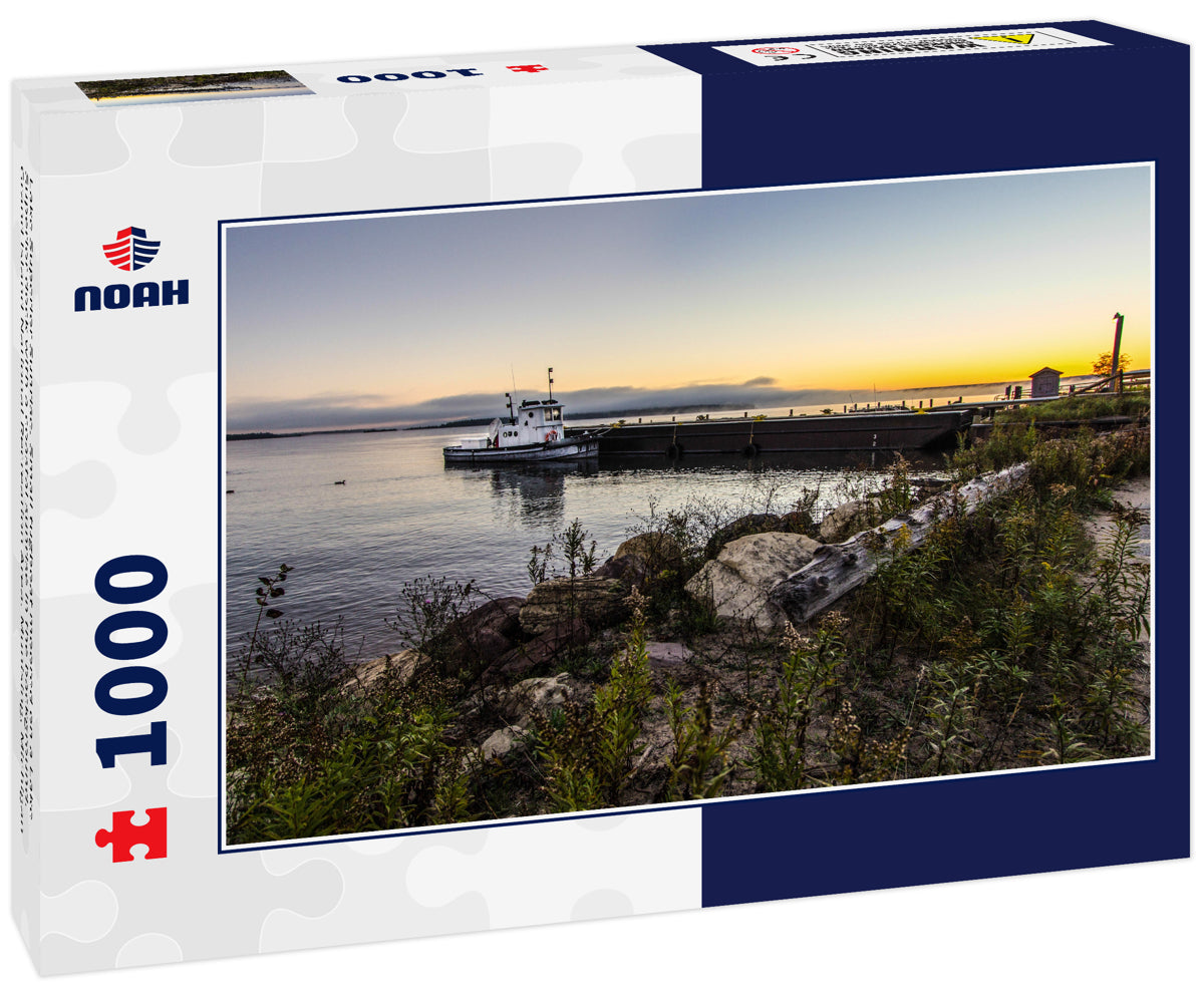 Lake Superior Sunrise. Small tugboat moored on a Lake Superior dock with a coastal sunrise in the background. Grand Island National Recreation Area. Munising, Michigan