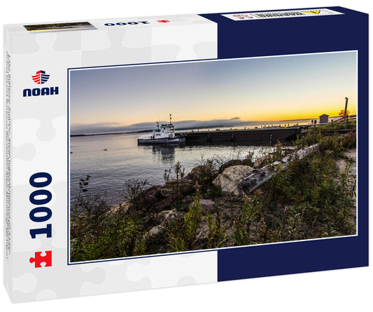 Lake Superior Sunrise. Small tugboat moored on a Lake Superior dock with a coastal sunrise in the background. Grand Island National Recreation Area. Munising, Michigan