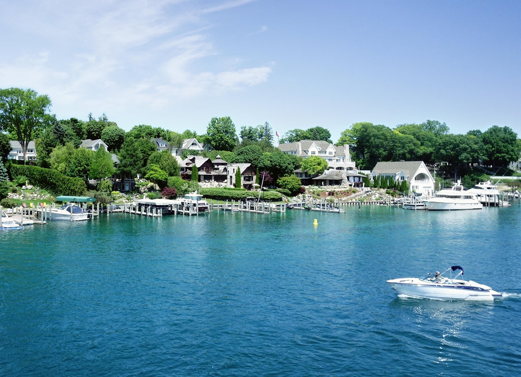 Lakefront homes and boats in the Round Lake in downtown Charlevoix Michigan