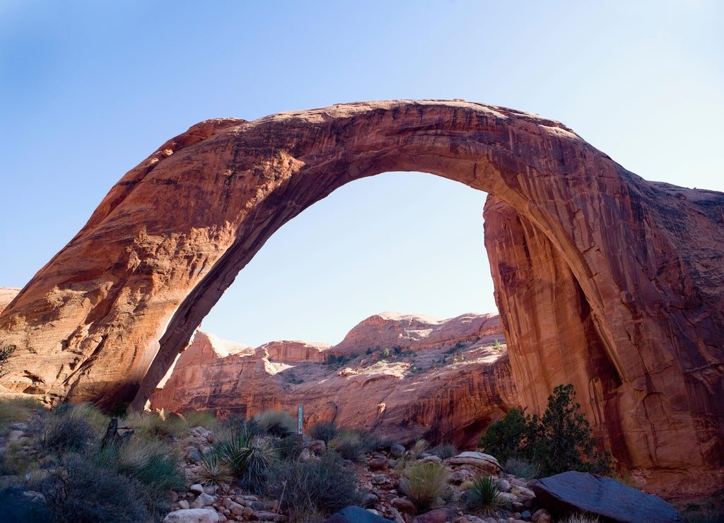 Natural arch on an arid landscape, Rainbow Arch, Lake Powell, Rainbow Bridge National Monument, Glen Canyon National Recreation Area, Utah, USA