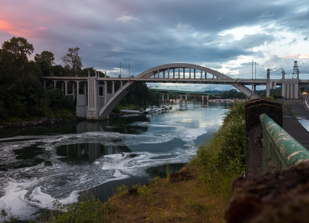 Dramatic sunset sky over Arch Bridge and Willamette river in Oregon City