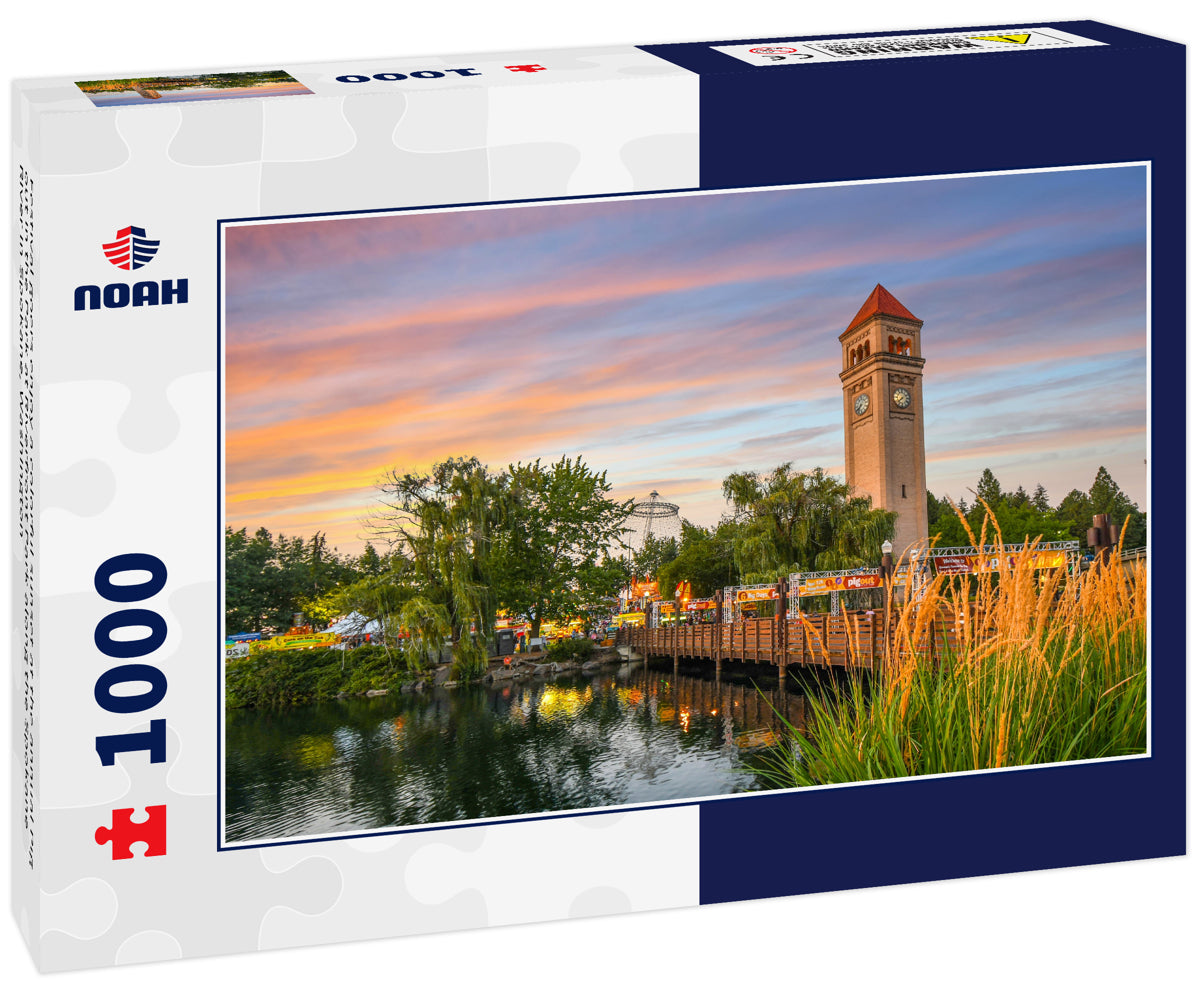 Festival goers enjoy a colorful sunset at the annual Pig out in the Park at Riverfront Park along the Spokane River in Spokane, Washington