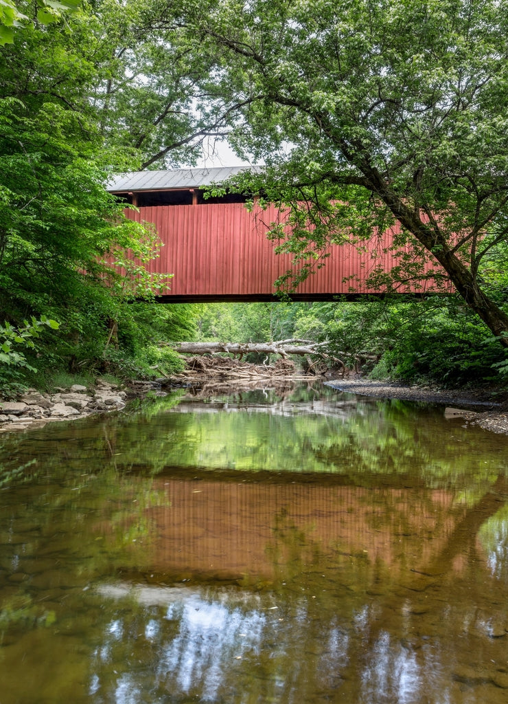 Built in 1891, the historic red Fletcher Covered Bridge crosses Tenmile Creek near Marshville in Harrison County, West Virginia
