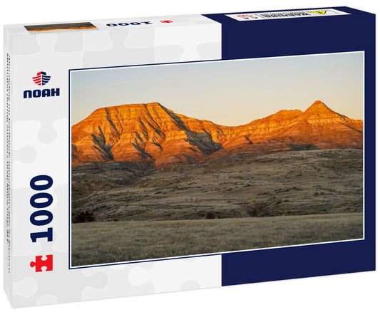 Alpenglow on badlands mountain cliffs in Eastern Montana during sunrise, near Miles City, MT