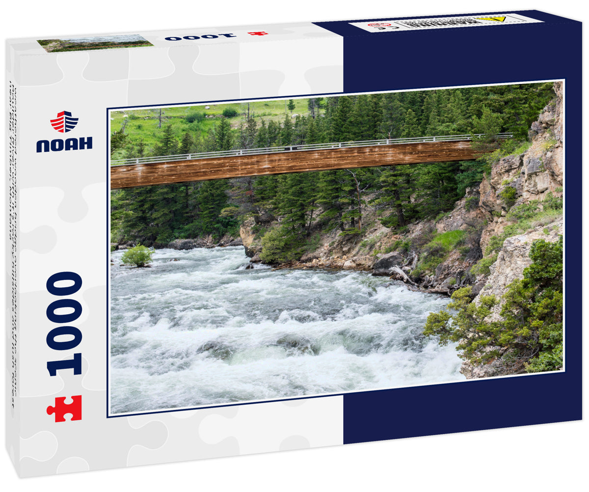 weathered wooden bridge overlooking the scenic Boulder River with it's rocky hillsides and lush forest near Big Timber, Montana