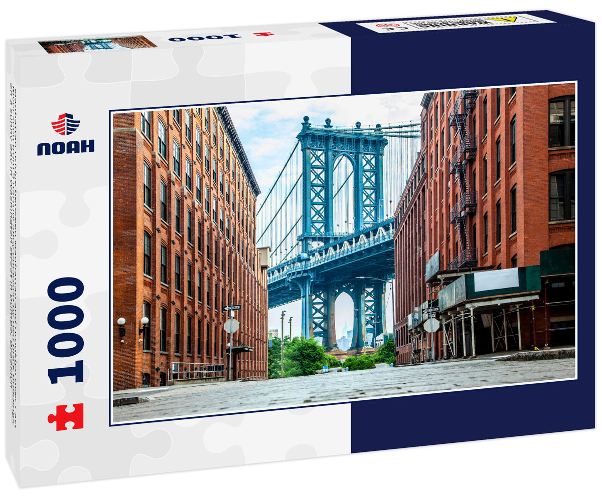 Manhattan Bridge between Manhattan and Brooklyn over East River seen from a narrow alley enclosed by two brick buildings on a sunny day in Washington street in Dumbo, Brooklyn