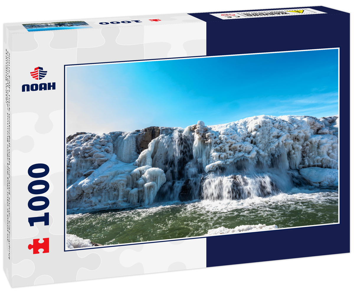 Sioux Falls Park waterfall with ice and snow. Cascading snowmelt water pouring over the top into a pool of standing water