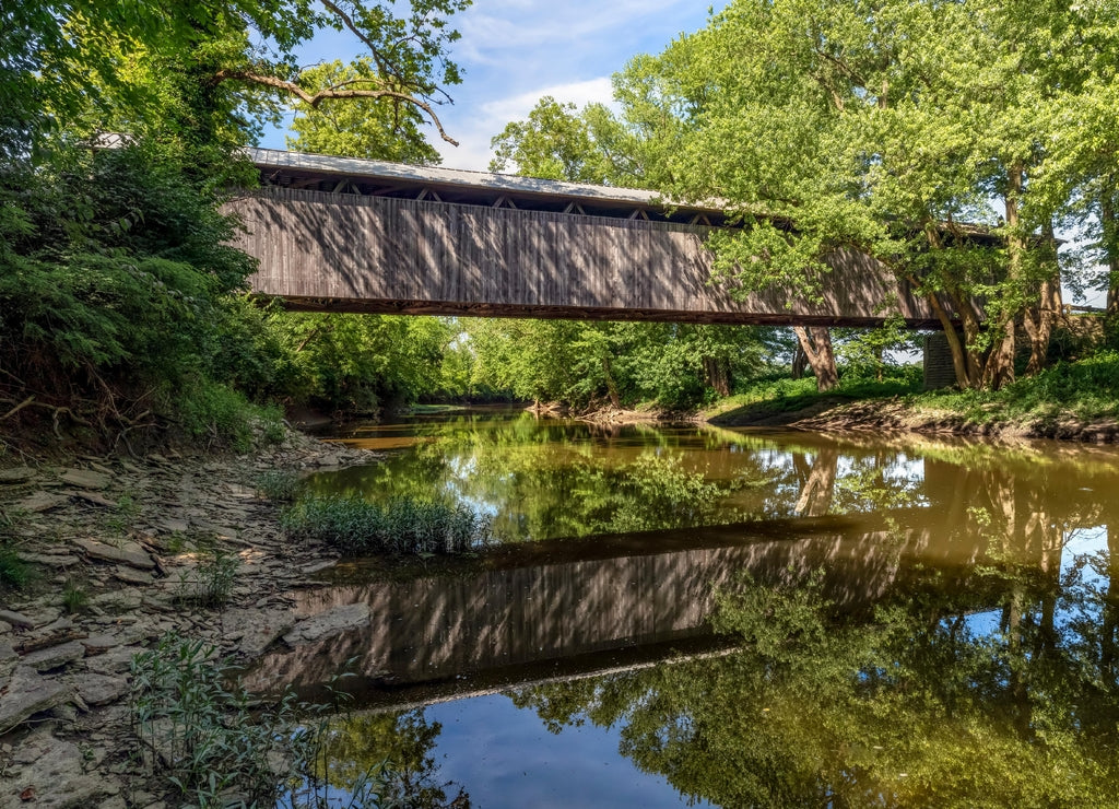 Displaying a beautiful reflection in the East Fork of the Little Miami River, historic McCafferty Road Covered Bridge was built in 1877 in rural Brown County