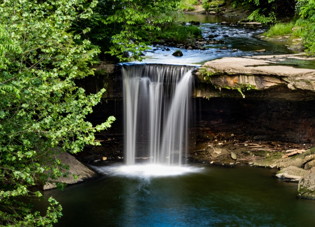 A beautiful creamy, milky waterfall with the motion frozen, nestled into a park in New Castle, Pennsylvania