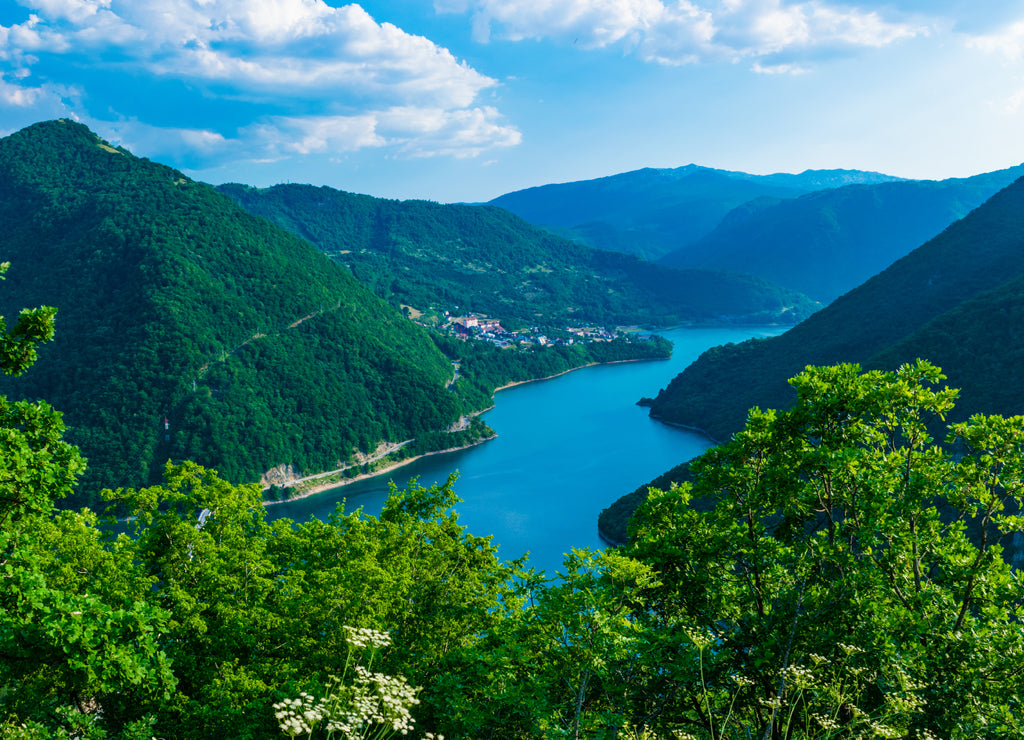 Summer landscape of lake and river Piva between high green mountains near Pluzine. Montenegro