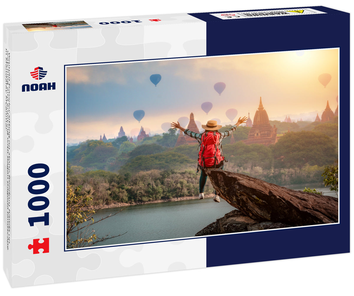 Woman traveler sitting on stone freedom hands up watching and enjoying with Bagan pagoda landscape in Mandalay Myanmar