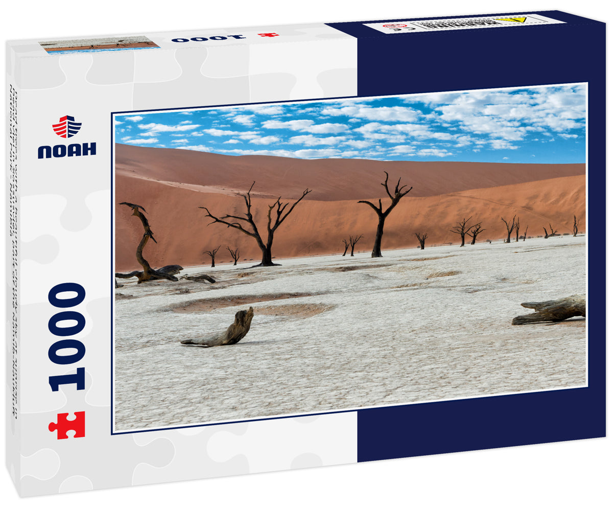 Dead trees with a beautiful cloudy sky at sunrise in Dead Vlei in Sossusvlei, part of the Namib-Naukluft National Park - Namibia