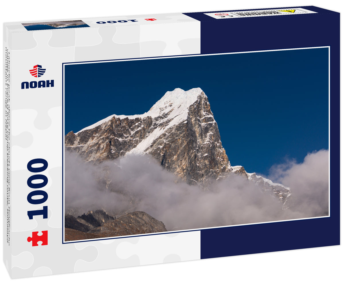 Taboche peak above the clouds view from Dingboche village in Everest base camp trekking route, Himalaya mountains range in Nepal