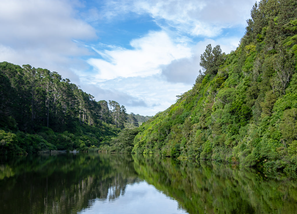 Karori reservoir mirror like reflection of New Zealand mountains