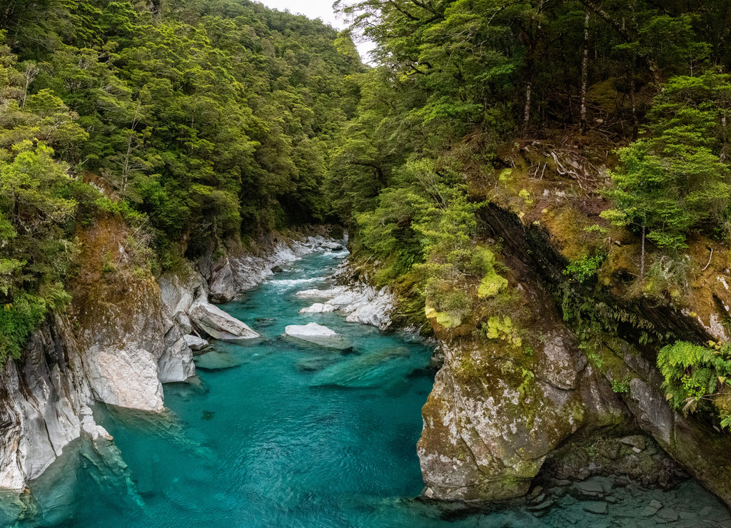 Colorful blue mountain river at the Haast pass, New Zealand