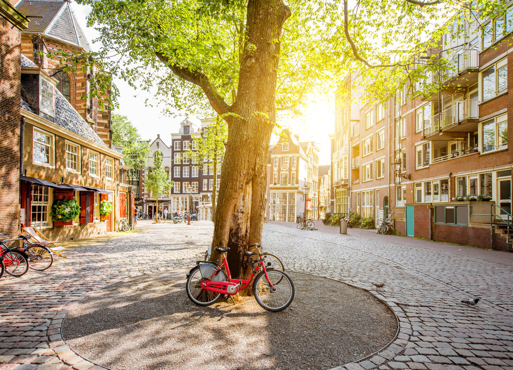 Morning view on the square with beautiful buildings near the Old Church in Amsterdam city