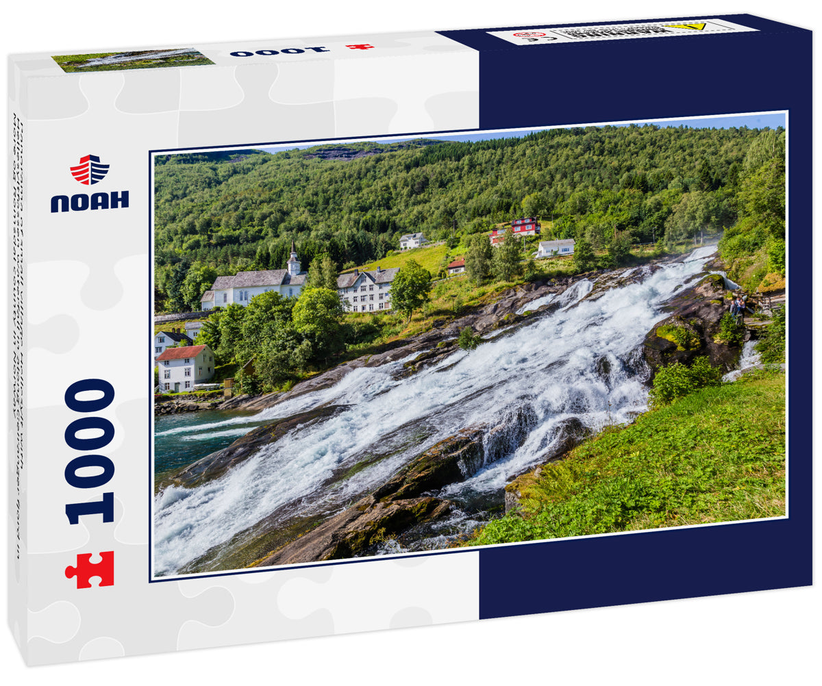 Panorama of small village Hellesylt with Hellesyltfossen waterfall in along Geiranger fjord in More og Romsdal county in Norway