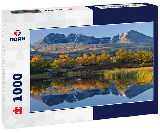 Reflection of Rondslottet mountain in a small lake. Rondane National park, Norway