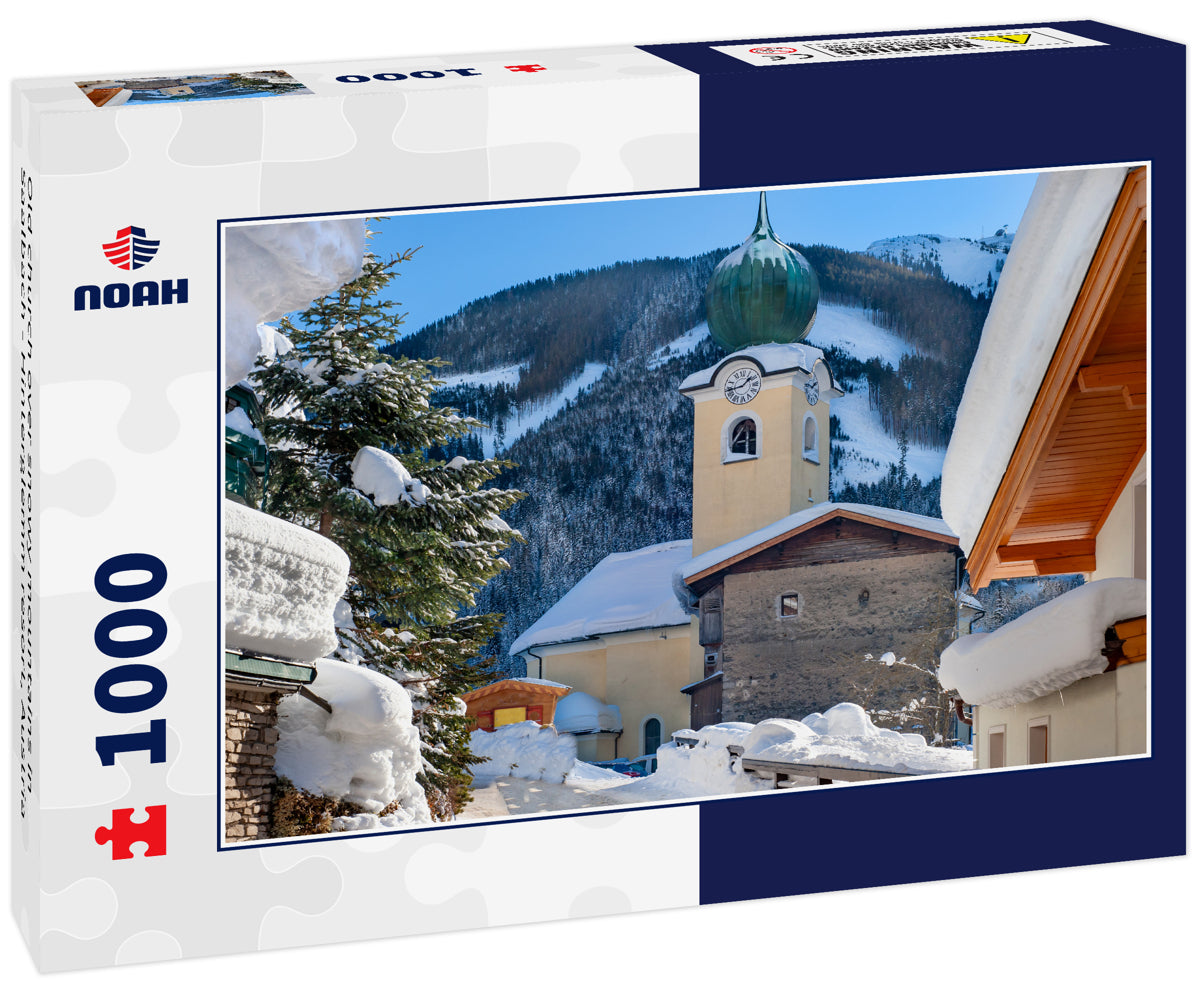 Old church over snowy mountains in Saalbach - Hinterglemm resort, Austria