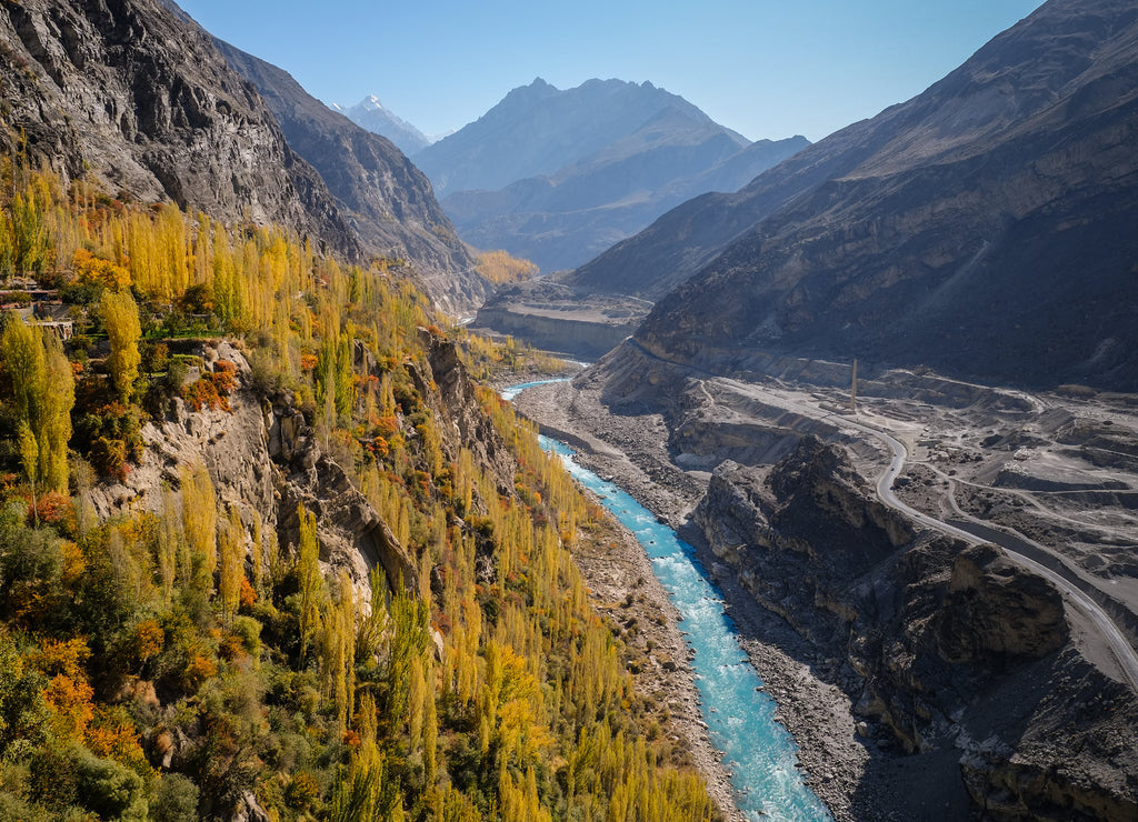 Colorful autumn view of Hunza from Altit fort show blue river flowing along the road through Karakoram mountain range, Gilgit-Baltistan, Pakistan