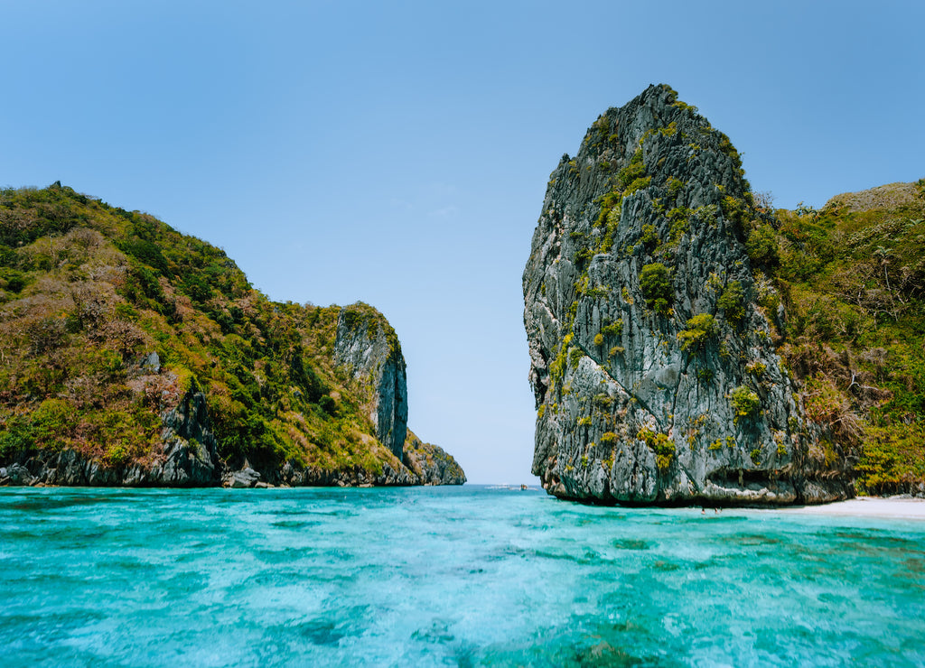 El Nido, Palawan, Philippines. Aerial view of towering cliffs in front of tropical Island with white sandy beach