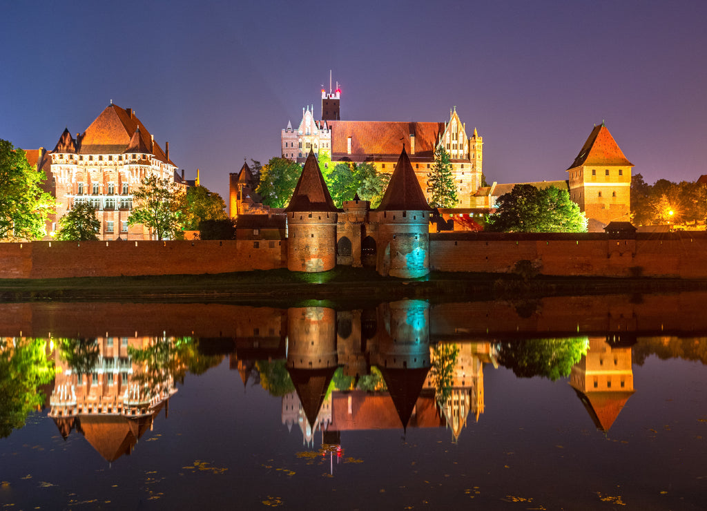 Malbork Castle from across the Nogat river at night. Poland