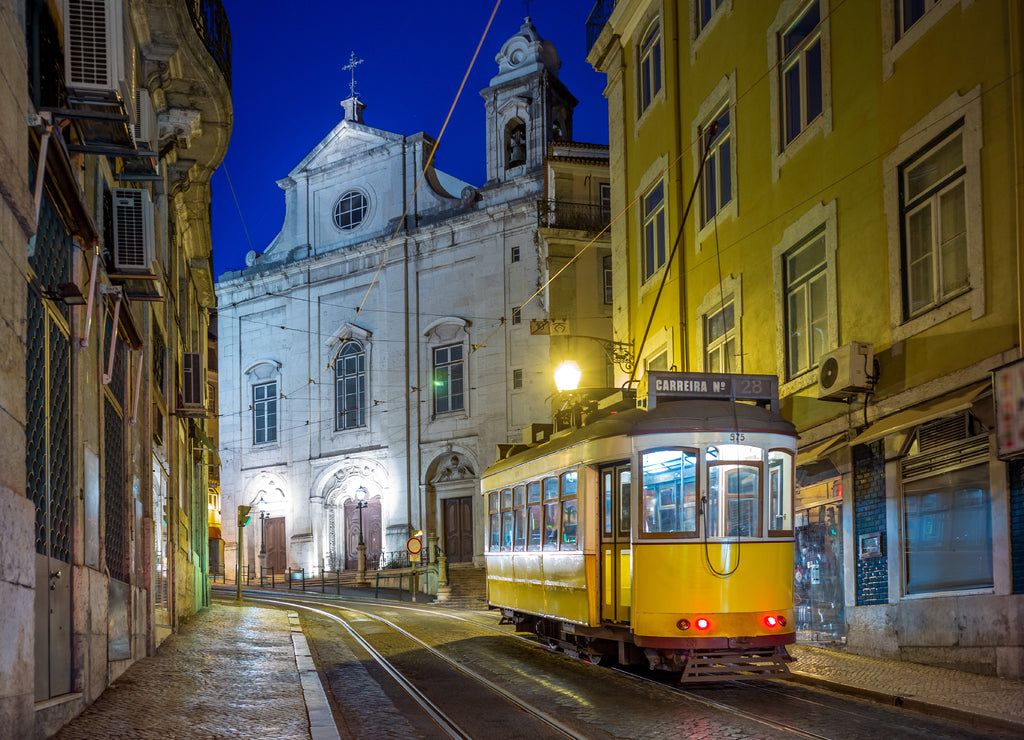 tram on line 28 in lisbon, portugal at night