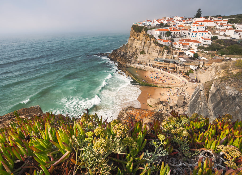 Sintra, Lisbon, Portugal. Azenhas do Mar white village landmark on the cliff and Atlantic ocean waves