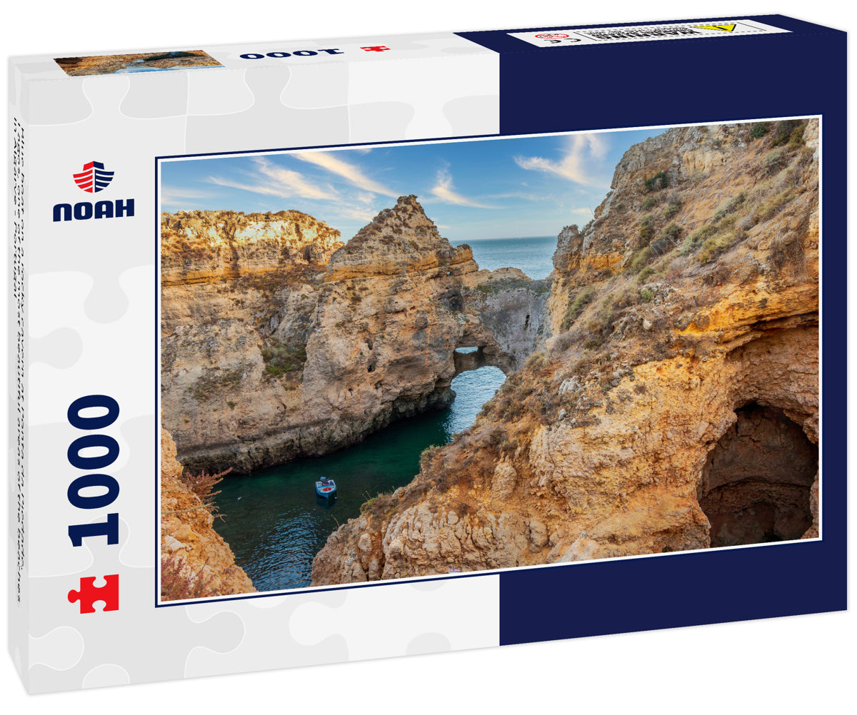 Blue boat on a rocky cavern at Ponta da Piedade, Lagos, one of the most beautiful areas of the beaches in Algarve - Portugal