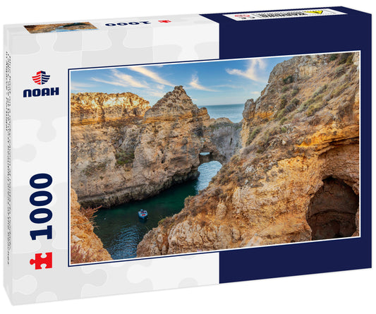 Blue boat on a rocky cavern at Ponta da Piedade, Lagos, one of the most beautiful areas of the beaches in Algarve - Portugal