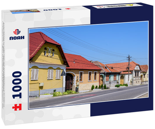 Colorful old houses near the fortitied church in Axente Sever village in Sibiu county, in Transylvania (Transilvania) region of Romania, in a sunny summer day