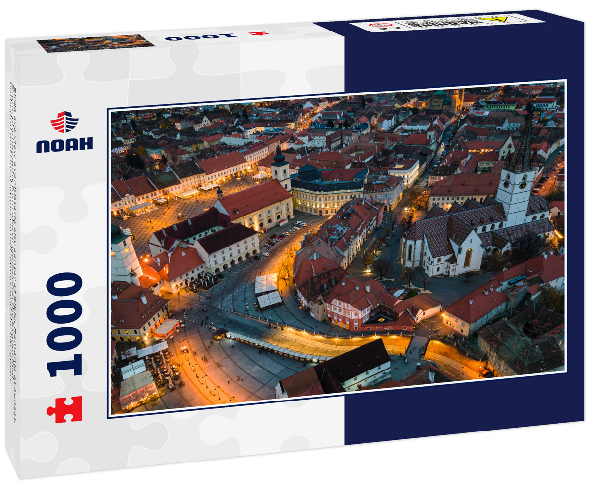 Birds eye view over historic city center of Sibiu, Romania at sunset. Drone photography from above containing the Evangelical Cathedral and Hued square, small square and the big square