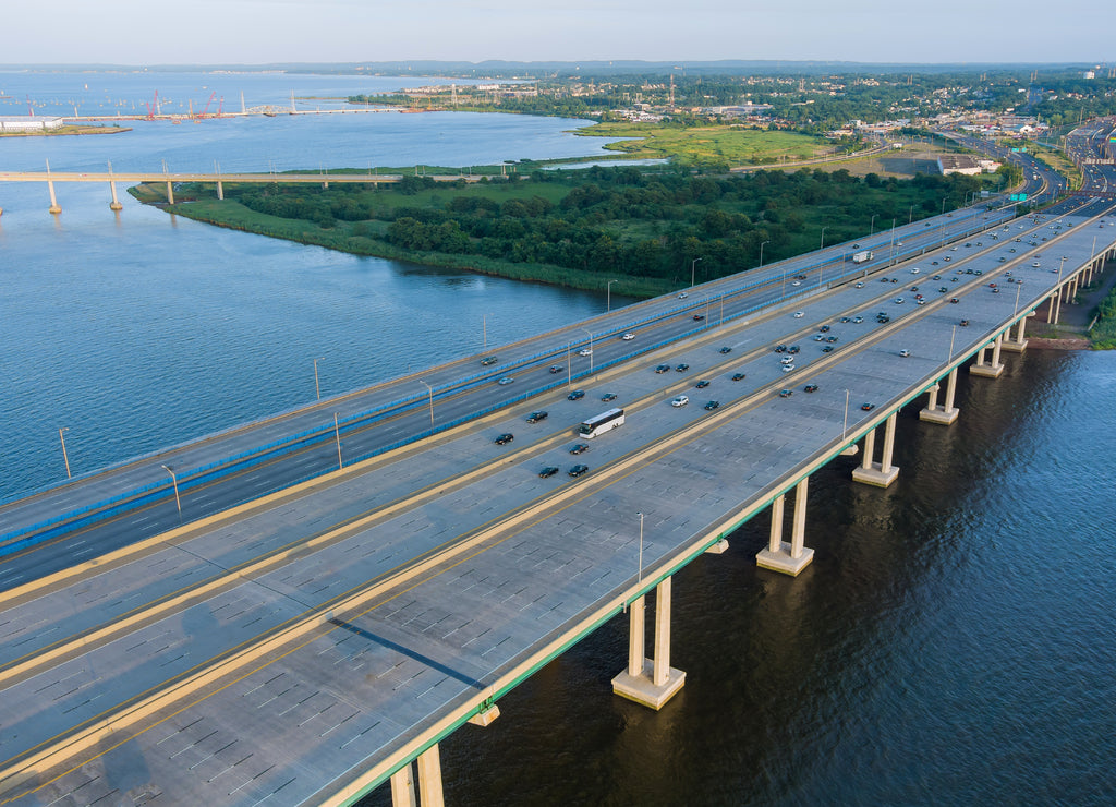 Aerial top view of huge complex road junction at cars driving on the Alfred E. Driscoll Bridge across the Raritan River New Jersey