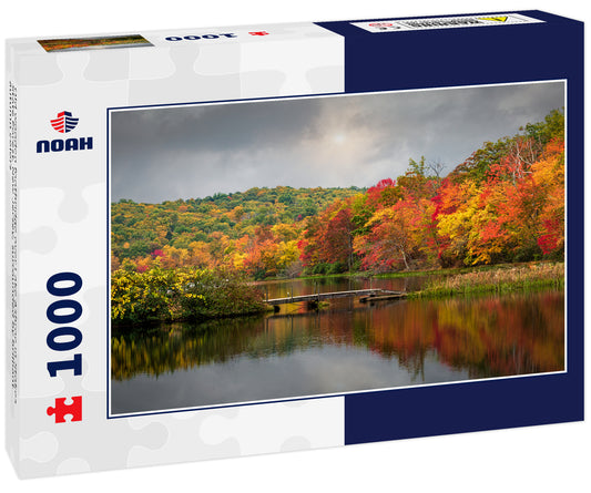 Old wooden footbridge over Lake Ashroe in Stokes State Forest, New Jersey, surrounded by brilliant autumn colors