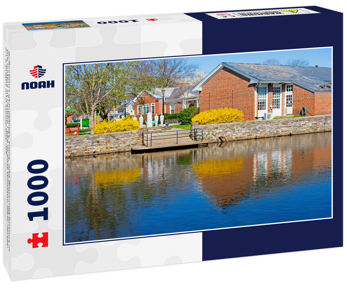 Reflections of buildings, trees, and flowering bushes in the waters of Peddie Lake in East Windsor, New Jersey, on a bright and sunny day -03