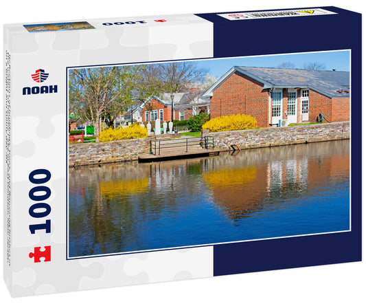 Reflections of buildings, trees, and flowering bushes in the waters of Peddie Lake in East Windsor, New Jersey, on a bright and sunny day -03