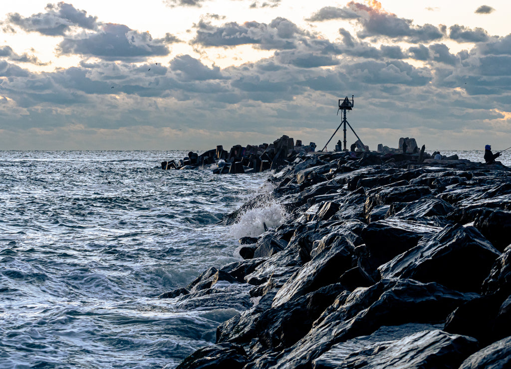 Waves crashing onto the breakwater at Manasquan Inlet at Sunrise, New Jersey