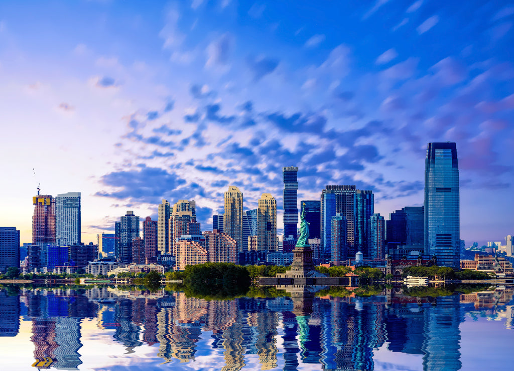 The skyline of Jersey City, New Jersey from New York Harbor with the Statue of Liberty in the foreground