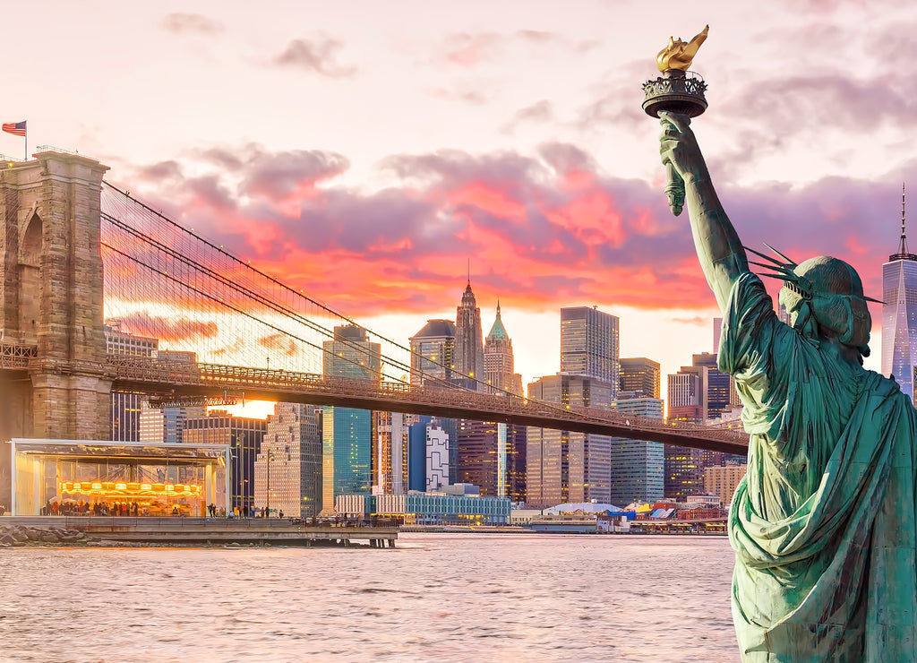 Statue Liberty and New York city skyline at sunset