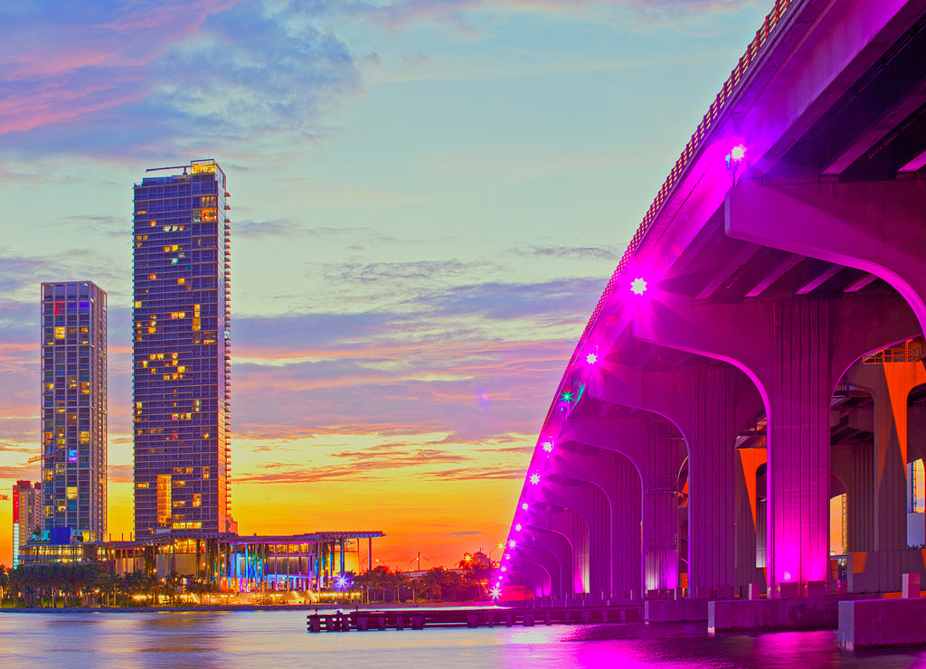 Miami Florida at sunset, colorful skyline of illuminated buildings and Macarthur causeway bridge