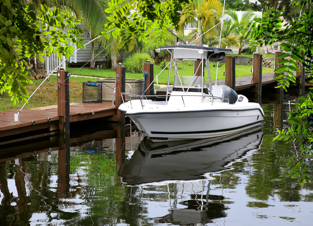 Close up parked boat at dock on canal in Florida, USA