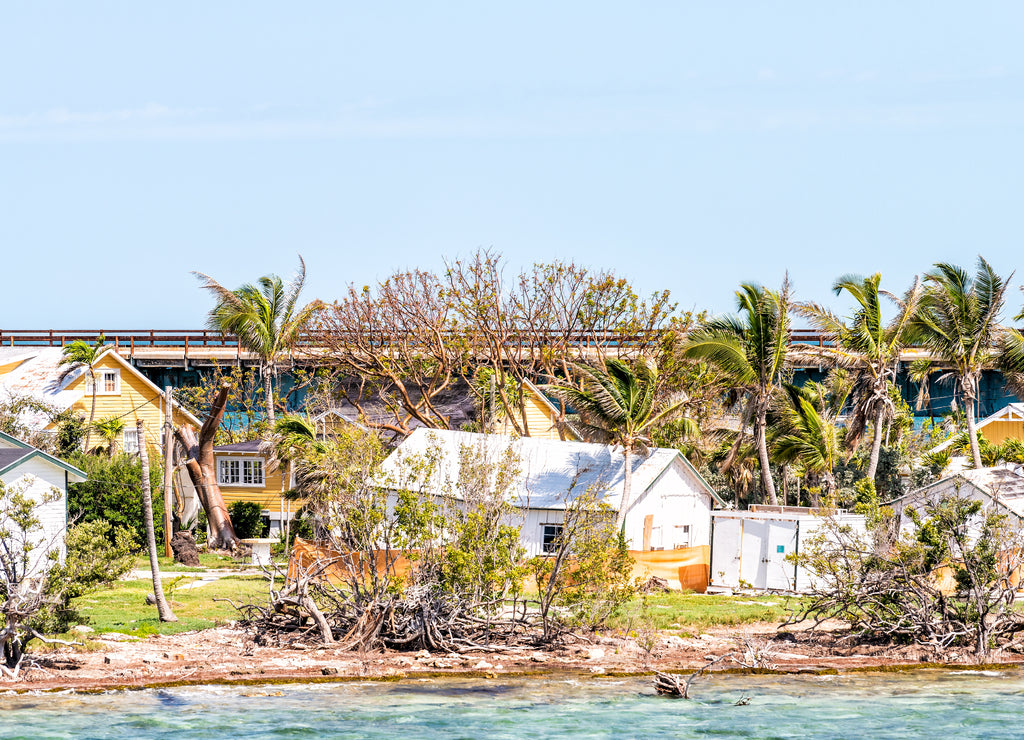 Many damaged, destroyed houses on beach by shore, coast in Florida keys, bridge after, aftermath of destruction of hurricane irma, houses after storm heavy wind