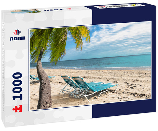 Relax on the beach. Palm tree and beach chairs at the coastline in Florida