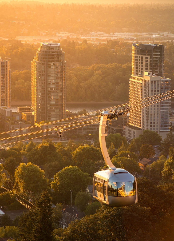 Cable car in Portland, Oregon, USA with wonderful view on sunrise with mt. Hood and aerial tram going to OHSU