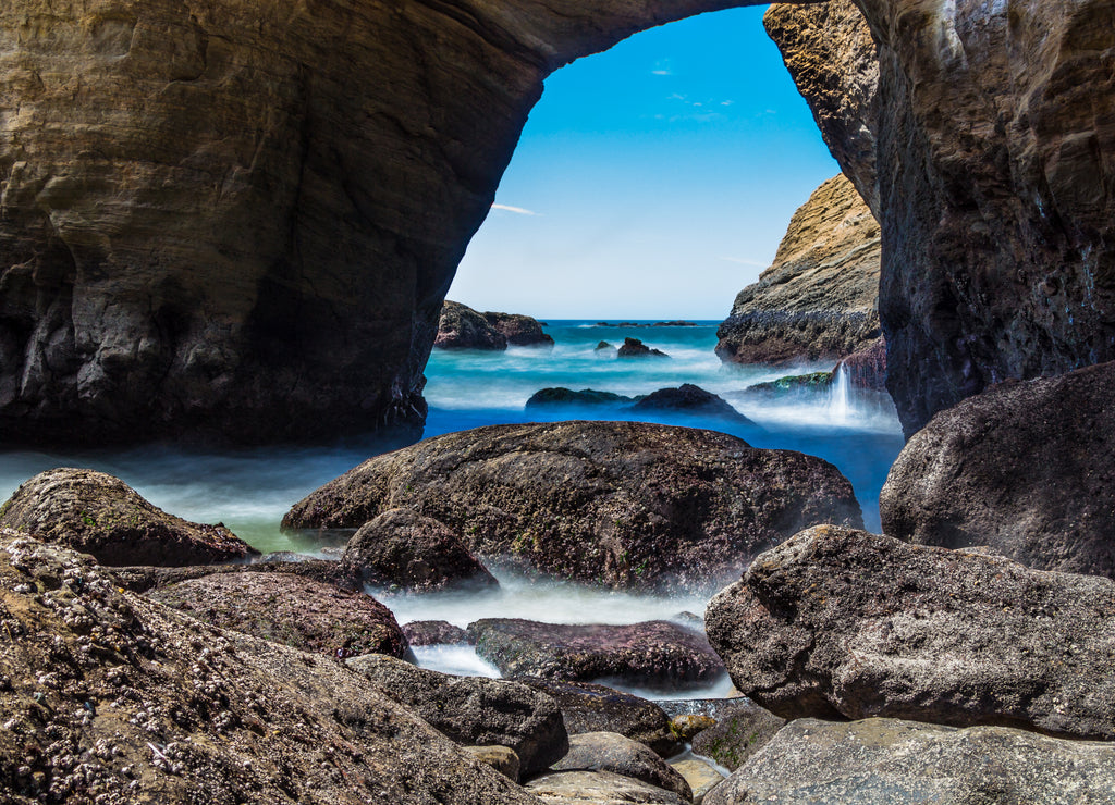 Smooth water flowing into Devils Punchbowl Oregon