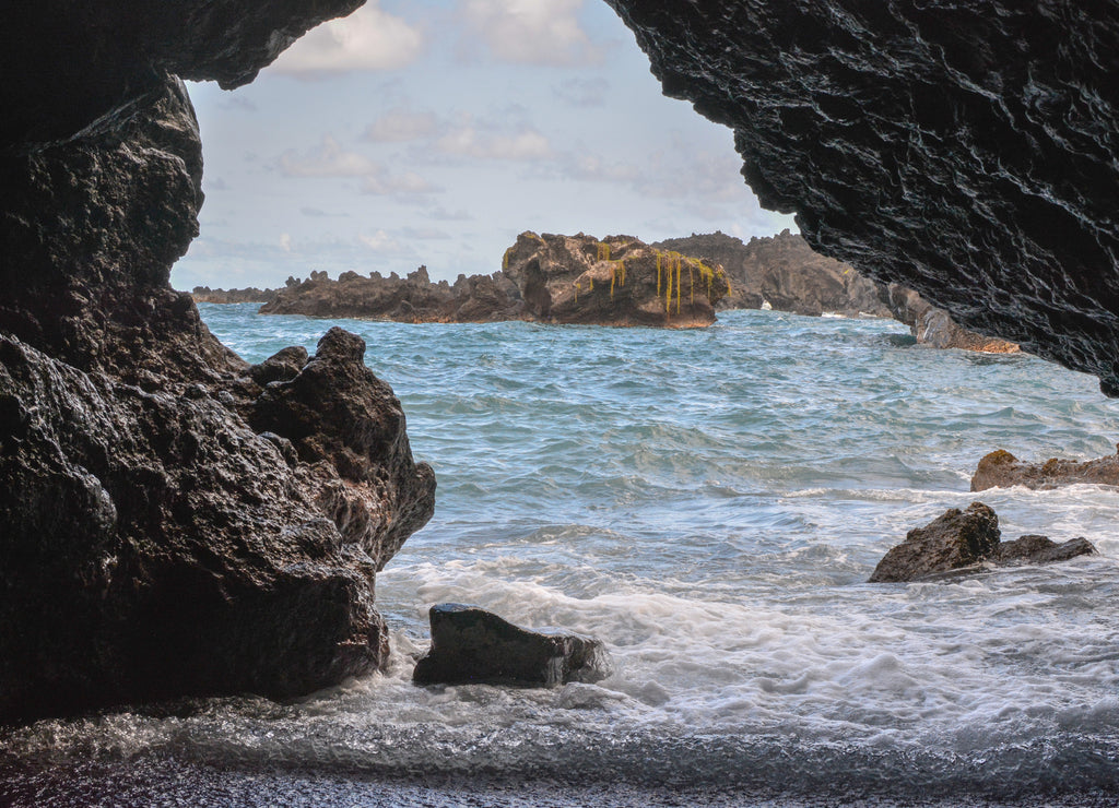 Looking out from a lava tube sea cave on the island of Maui, Hawaii