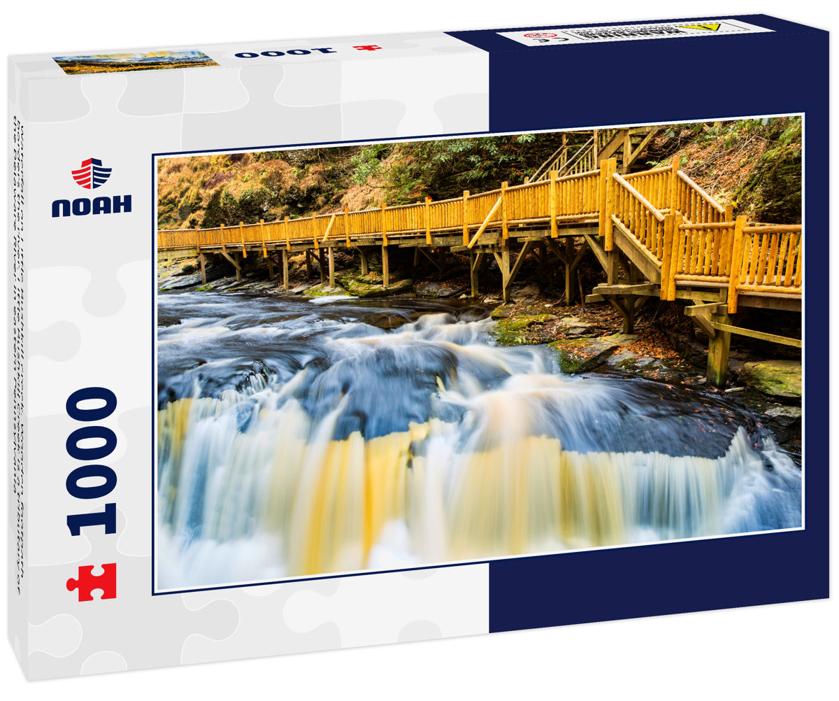 Waterfall on Little Bushkill creek. Wooden footpath borders the river. Little Bushkill Creek is a tributary of the Delaware River in eastern Pennsylvania