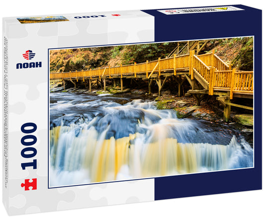 Waterfall on Little Bushkill creek. Wooden footpath borders the river. Little Bushkill Creek is a tributary of the Delaware River in eastern Pennsylvania